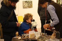 kid looking into microscope